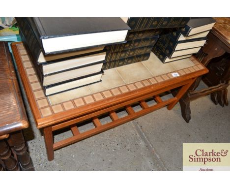 A teak and tile topped coffee table