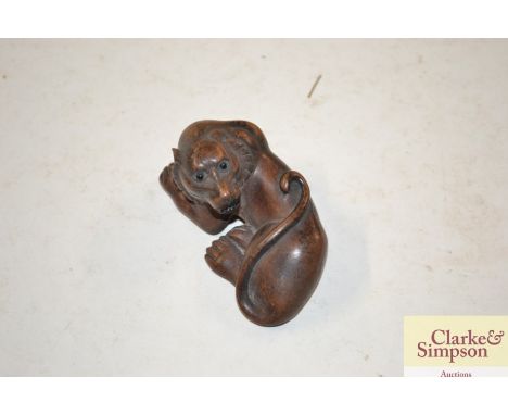 A Japanese wooden dog Netsuke