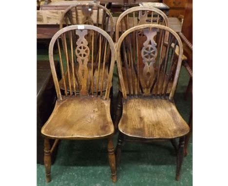 Set of four elm hard seated stick back wheel back kitchen chairs, on turned front legs and H-stretchers, comprising three din