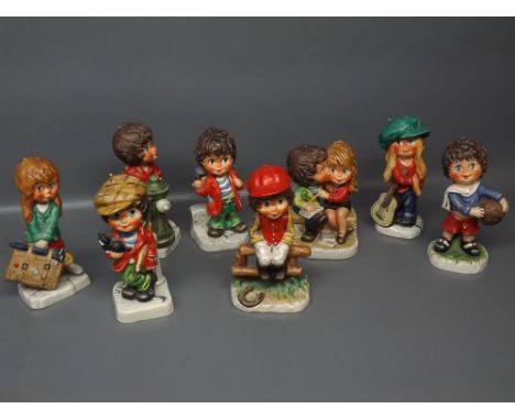 Group: eight assorted Goebel German figures of young boys and girls in various poses 