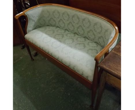 Edwardian mahogany two seater cottage sofa, in the Macintosh style, with green floral upholstered seat and back and tapering 