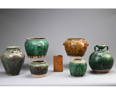 A GROUP OF CHINESE GREEN AND OCHRE GLAZED STORAGE JARS AND A BAMBOO BRUSH POT. Comprising: a green glazed globular example wi