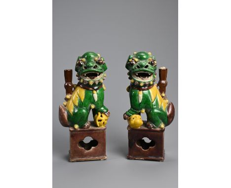 A PAIR OF CHINESE SANCAI GLAZED PORCELAIN JOSS STICK HOLDERS, 19/20TH CENTURY. In the form of a foo dogs seated on an openwor