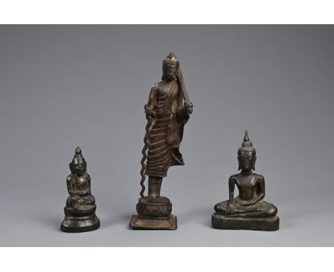 THREE SOUTH EAST ASIAN BRONZE MODELS OF BUDDHAS. Comprising: a buddha Shakyamuni, Laos, seated in dhyanasana, 18th-19th centu