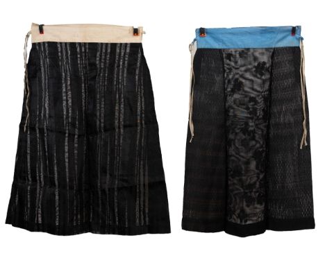 TWO EARLY 20TH CENTURY CHINESE BLACK SILK GAUZE SUMMER SKIRTS. The first with floral embroidering and gauze stripes, with cre