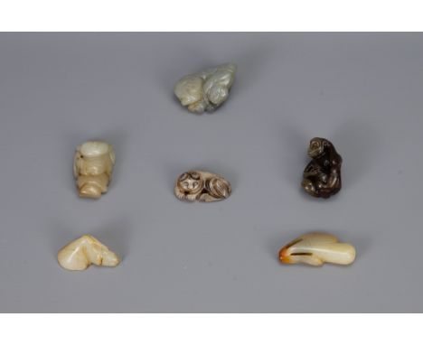 SIX CHINESE CARVED JADE PENDANTS, of different forms to include hanging elongated fruit, monkey with peach, lotus, recumbent 