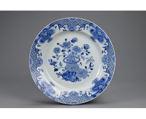 A LARGE CHINESE BLUE AND WHITE PORCELAIN CHARGER, 18TH CENTURY. Decorated with peonies in a vase with ruyi sceptre and floral