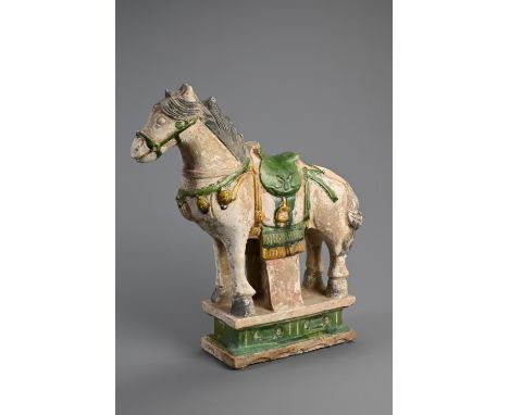 A LARGE CHINESE SANCAI GLAZED POTTERY MODEL OF A HORSE, MING DYNASTY (1368-1644). Standing four square on a raised pedestal w