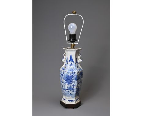 A 19TH CENTURY CHINESE PORCELAIN BLUE AND WHITE HEXAGONAL BALUSTER VASE ADAPTED AS A LAMP. With lion dog handles, painted wit