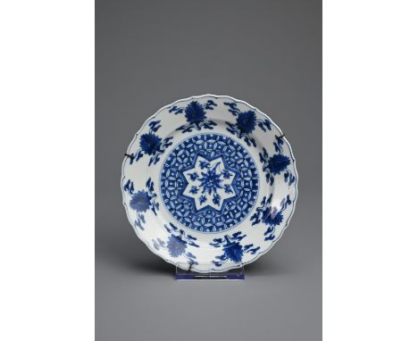 A CHINESE BLUE AND WHITE PORCELAIN DISH, 18TH CENTURY. Of lobed form decorated with lotus motifs. With six character mark of 