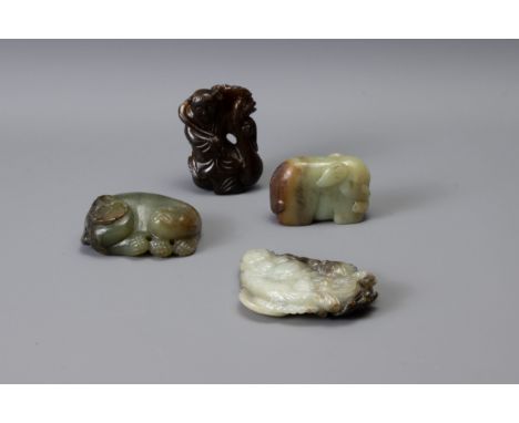 FOUR CHINESE CARVED JADE ITEMS, of different forms to include Liu Hai, recumbent lion with butterfly, boy and goose group and