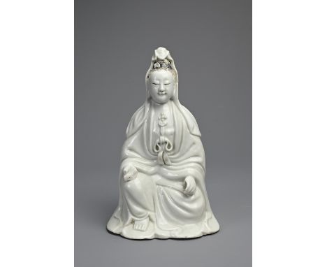 A CHINESE DEHUA PORCELAIN FIGURE OF GUANYIN, 19TH CENTURY. Seated, dressed in long robes with hair tied up into a high chigno