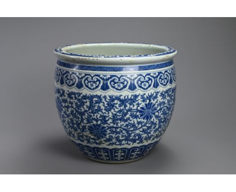 A LARGE 19TH CENTURY CHINESE PORCELAIN BLUE AND JARDINIERE. Painted in the Ming style with lotus, trailing tendrils and scrol