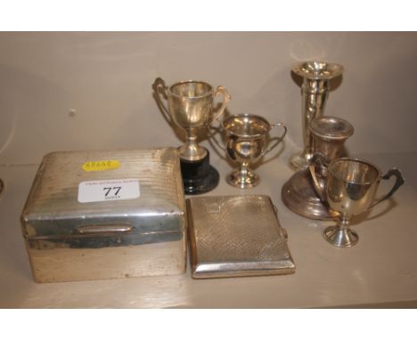 A quantity of mixed silver to include a cigarette box, cigarette case, small trophy cups, spill vase, and a dwarf candlestick