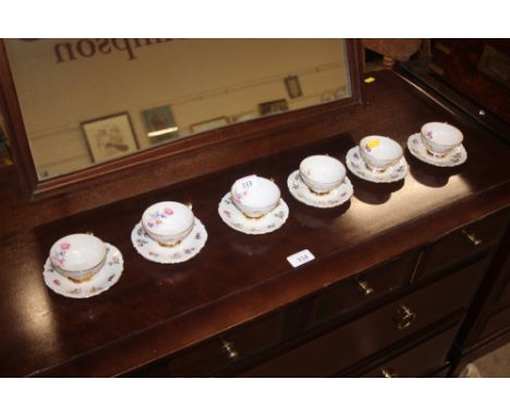 A set of six German floral decorated coffee cups and saucers 