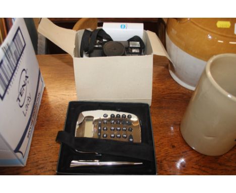A Minolta camera and a calculator and pen set 