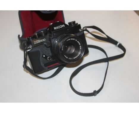 A Ricoh camera with carrying case
