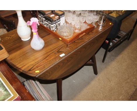 An Ercol drop leaf kitchen table and a set of four chairs