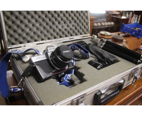 A Minolta camera with accessories and carrying case