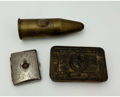 A small collection of militaria items to include a Princess Mary 1914 Christmas tin, a trench art lighter, and a white metal 
