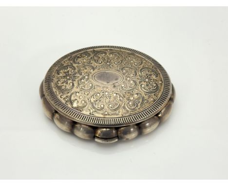A silver Kigu compact with scalloped edges, foliate design on lid with gilt decoration. Internal mirror intact. 86mm x 72mm. 