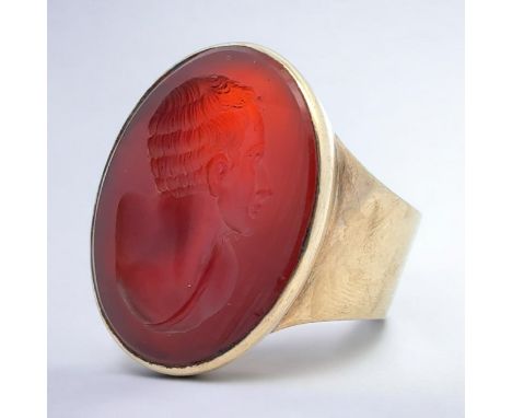 A gold carnelian intaglio seal ring depicting a Roman man. Unmarked but tests as 9ct using XRF. Size Q. Ring head 27mm x 21mm