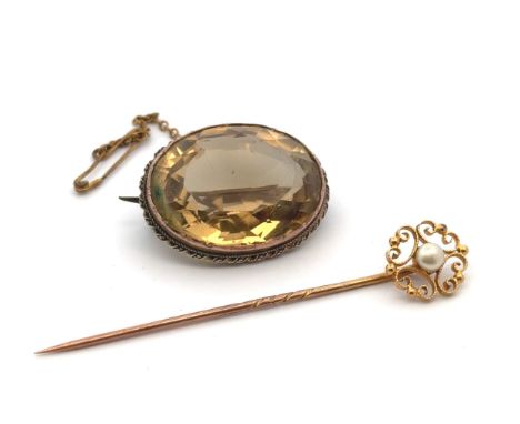 A citrine brooch in yellow metal, and a pearl and yellow metal tie pin.