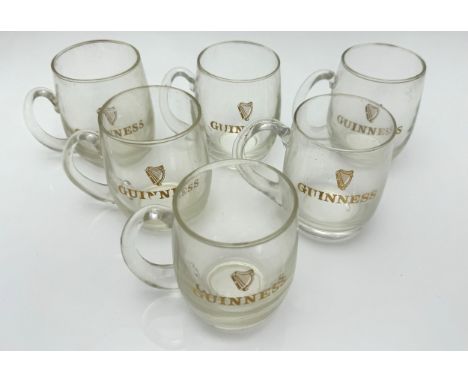 Guinness, box containing six Guinness half pint glass mugs bearing the harp logo with Guinness written in gold lettering. (6)