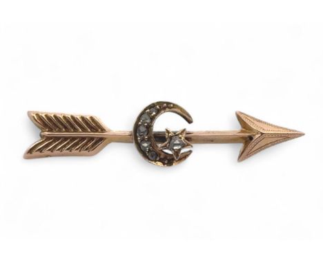 An unmarked gold arrow brooch with central moon and star set with rose cut diamonds. Weight 2.01g, length 4cm.