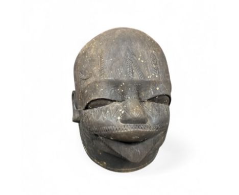 An early to mid 20th century carved wood Makonde African helmet Mask, hollow interior with carved teeth. Some deterioration t