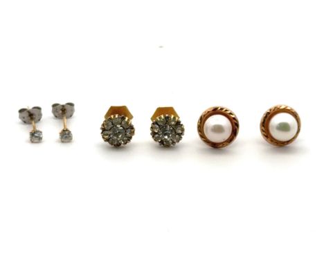 Three pairs of gold earrings. A pair of 9ct hallmarked white stone cluster earrings , a pair of white stone studs with white 