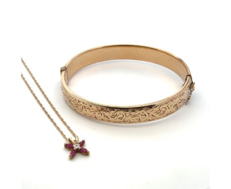 A 9ct gold bangle with metal core, and a 9ct gold ruby pendant necklace