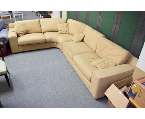 A corner sofa upholstered in oatmeal fabric 