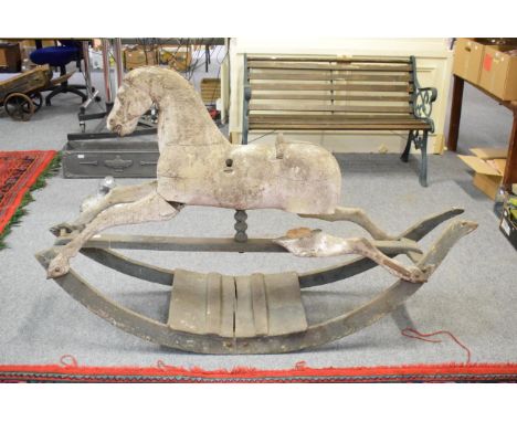 A carved rocking horse, circa 1900, in need of restoration 