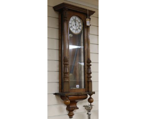 A 19th century Vienna wall clock, with enamelled Roman dial and subsidiary seconds, in architectural walnut case, 3ft 4ins