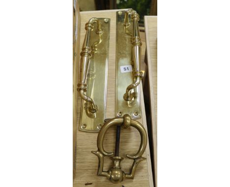 Two brass door pulls and a door knocker