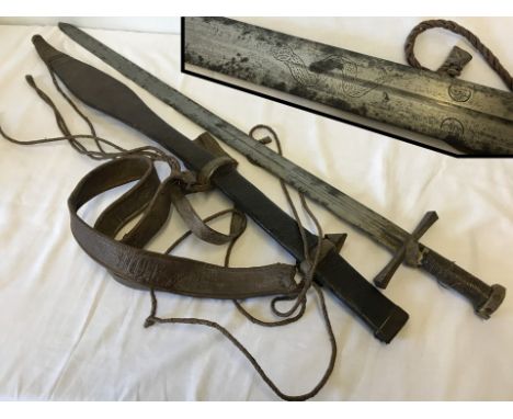 An antique Sudanese Kaskara sword & scabbard. As used by Mahdi's forces at Battle of Omdurman. Blade etched with snake design