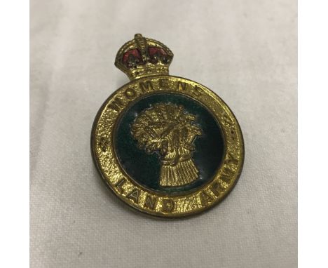 A WW2 Woman's Land Army enamel pin badge.  