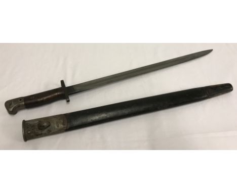 A 1907 British bayonet & leather scabbard. Blade marked Wilkinson & dated 1907. 