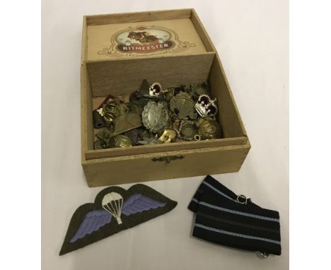 A box of military badges, buttons and cloth parachutists patch.  
