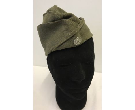 WWII German Ostvolk Eastern Peoples side cap. With skull and crossbones button detail to front. Small areas of moth damage. 