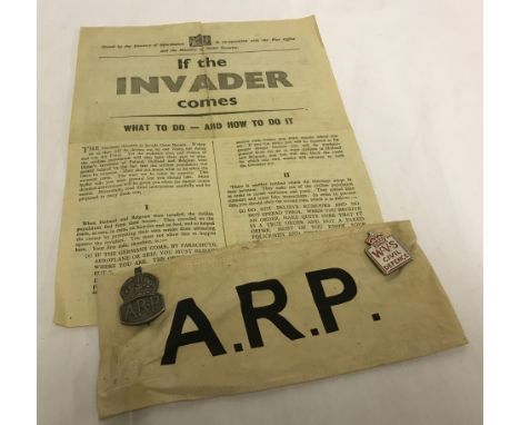 WWII ARP cloth armband with hallmarked silver ARP badge. Civil defence badge and If The Invader Comes leaflet. 