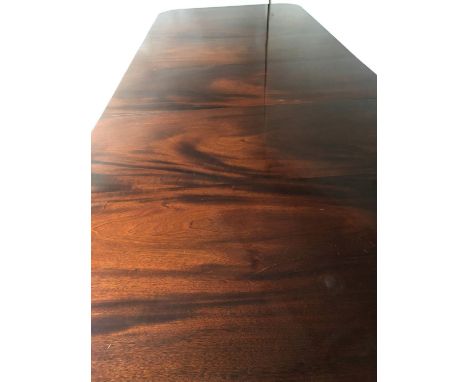 TILLMAN TWO PILLAR DINING TABLE, Regency design figured mahogany with two additional leaves and twin pillar outswept supports