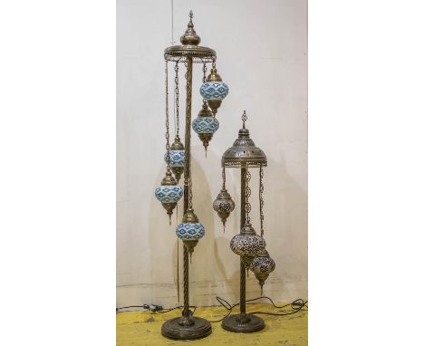 STANDING LAMPS, Moroccan patinated brass, with five ceramic and glass adorned shades, 165cm H, and a smaller similar lamp, 10