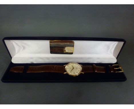 A 1960's gold Universal Geneve Gentleman;s wristwatch , manual side wind with cream dial having applied stick markers and min