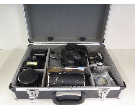 A flight case containing an Olympus OM2 camera body, automatic Olympus, Tamron Tele Converter, National PE-3056 flash, a 1:1.