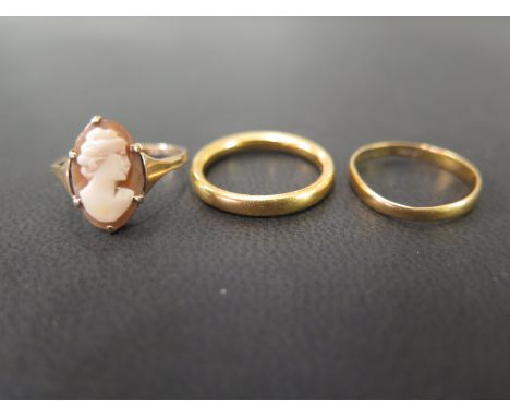 Two 22ct gold band rings - Hallmarked Birmingham - Sizes L and N - Weight approx 6.2gms - Together with a shell cameo ring - 