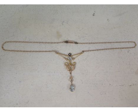 A 15ct yellow gold pendant with small pearls set and light blue aquamarine stones on yellow metal chain 
Condition report: Go