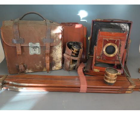 A Thornton Pickard Imperial triple extension teak and lacquered brass folding plate camera with tripod, plates and three lens
