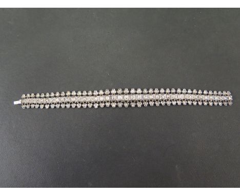 A late 19th/early 20th century articulated diamond bracelet - The graduated old-cut diamond line to the trefoil sides, each s